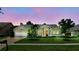 Beautiful home featuring a lush green lawn, mature trees, and a brick driveway at 3618 Rothbury Dr, Belle Isle, FL 32812