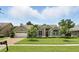 Charming single-story home with a well-manicured lawn and a two-car garage at 3618 Rothbury Dr, Belle Isle, FL 32812
