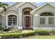 Charming home featuring a vibrant red front door and a landscaped front yard at 3618 Rothbury Dr, Belle Isle, FL 32812
