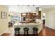 Open kitchen with a breakfast bar, granite countertops, modern appliances, and plenty of natural light at 3618 Rothbury Dr, Belle Isle, FL 32812