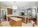Bright, open kitchen with a central island, granite countertops, stainless appliances, and view to the living room at 3618 Rothbury Dr, Belle Isle, FL 32812