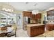 Spacious kitchen featuring a granite island, stainless steel appliances, and access to the outdoor pool area at 3618 Rothbury Dr, Belle Isle, FL 32812