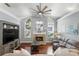 Cozy living room with a fireplace, large windows, and hardwood floors at 3618 Rothbury Dr, Belle Isle, FL 32812