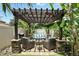 Outdoor seating area with a pergola, fire pit, and lush landscaping at 3618 Rothbury Dr, Belle Isle, FL 32812
