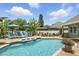 Relaxing pool area with lounge chairs and umbrellas, perfect for outdoor enjoyment at 3618 Rothbury Dr, Belle Isle, FL 32812