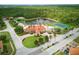 Community with clubhouse, pond, pool, tennis court, and lush landscaping at 436 Caraway Dr, Kissimmee, FL 34759
