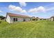 Expansive backyard with lush green grass and a row of homes in the distance at 436 Caraway Dr, Kissimmee, FL 34759