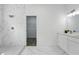Modern bathroom with dual vanity, marble tile, toilet, and walk-in shower at 436 Caraway Dr, Kissimmee, FL 34759