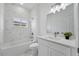 Elegant bathroom with marble tile, modern vanity, toilet, and a bathtub with shower at 436 Caraway Dr, Kissimmee, FL 34759