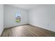Bright bedroom featuring light hardwood floors, white walls, and a window to the outside at 436 Caraway Dr, Kissimmee, FL 34759
