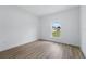 Bright bedroom featuring light hardwood floors, white walls, and a window to the outside at 436 Caraway Dr, Kissimmee, FL 34759