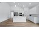 Bright open kitchen featuring white cabinets, stainless steel appliances and a large island at 436 Caraway Dr, Kissimmee, FL 34759