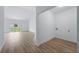 Bright living room with wood-look floors leading to a utility room with washer and dryer hookups at 436 Caraway Dr, Kissimmee, FL 34759