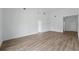 Open living area with wood-look floors and a view of the entry hall at 436 Caraway Dr, Kissimmee, FL 34759