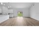 Bright living room featuring light hardwood floors, white walls, and sliding glass doors to the yard at 436 Caraway Dr, Kissimmee, FL 34759