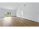 Spacious living room with wood-look floors and sliding glass doors to the backyard at 436 Caraway Dr, Kissimmee, FL 34759