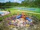 Fun playground in a gated community with a slide, swings, and seesaws for children at 436 Caraway Dr, Kissimmee, FL 34759