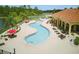 Overhead view of community pool with sun loungers and umbrellas by the clubhouse at 436 Caraway Dr, Kissimmee, FL 34759