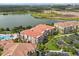 Stunning aerial view of condos with lake, pool, and lush landscaping, offering a serene and luxurious living environment at 5012 Shoreway Loop # 10107, Orlando, FL 32819