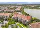 Beautifully landscaped community with a pool, lake, and attractive building exteriors at 5012 Shoreway Loop # 10107, Orlando, FL 32819