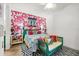 Stylish bedroom with bold patterned wallpaper, bright decor, and unique furniture pieces at 5012 Shoreway Loop # 10107, Orlando, FL 32819