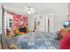 Unique bedroom with colorful wallpaper, decor, and comfortable furniture at 5012 Shoreway Loop # 10107, Orlando, FL 32819