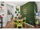 Dining area showcasing a vibrant green wall, round table, and eclectic decor at 5012 Shoreway Loop # 10107, Orlando, FL 32819