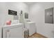Well-lit laundry room featuring a washer, dryer, and storage space at 5012 Shoreway Loop # 10107, Orlando, FL 32819