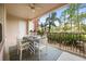 Relaxing covered patio with seating, a table, and a peaceful outdoor view at 5012 Shoreway Loop # 10107, Orlando, FL 32819