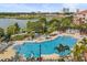 Large community pool with plenty of lounge chairs, umbrellas, and scenic lake views at 5012 Shoreway Loop # 10107, Orlando, FL 32819
