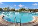 Large swimming pool with clear blue water, surrounded by lush landscaping and comfortable lounge seating for relaxation at 5012 Shoreway Loop # 10107, Orlando, FL 32819