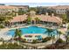 Resort-style pool area with palm trees, lounge chairs, and a spacious pool deck at 5012 Shoreway Loop # 10107, Orlando, FL 32819