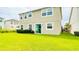 Spacious backyard featuring vibrant green grass and a sliding glass door for easy indoor-outdoor flow at 5107 Longmeadow Park St, Orlando, FL 32811