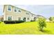 Expansive backyard with lush green lawn and sliding glass doors, perfect for outdoor enjoyment at 5107 Longmeadow Park St, Orlando, FL 32811