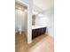 Bathroom with double vanity, tile floors and toilet with an open doorway at 5107 Longmeadow Park St, Orlando, FL 32811