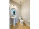 Powder room featuring a pedestal sink, modern lighting, and tile flooring at 5107 Longmeadow Park St, Orlando, FL 32811