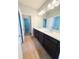 Bathroom with double vanity sink with dark cabinets and tile floors at 5107 Longmeadow Park St, Orlando, FL 32811