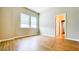 Bright bedroom boasts two windows, neutral walls, and wood-look flooring at 5107 Longmeadow Park St, Orlando, FL 32811