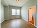 Bedroom with ample natural light, wood-look floors, and neutral gray walls at 5107 Longmeadow Park St, Orlando, FL 32811