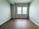 Spacious room with two windows and wood floors offers plenty of natural light at 5107 Longmeadow Park St, Orlando, FL 32811