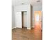 Bedroom with wood-look flooring features a closet and view into other rooms at 5107 Longmeadow Park St, Orlando, FL 32811