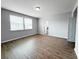 Bedroom features wood-look flooring and large windows at 5107 Longmeadow Park St, Orlando, FL 32811