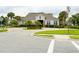 A beautiful clubhouse entrance with manicured landscaping and a roundabout driveway at 5107 Longmeadow Park St, Orlando, FL 32811