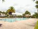 Beautiful community pool area with palm trees, lounge chairs, and clear water for relaxation at 5107 Longmeadow Park St, Orlando, FL 32811