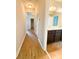 Hallway view leading to bathroom, features wood-look flooring and neutral-toned walls at 5107 Longmeadow Park St, Orlando, FL 32811