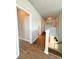 Bright hallway features hardwood floors and access to multiple rooms and staircase at 5107 Longmeadow Park St, Orlando, FL 32811