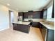 Modern kitchen with stainless steel appliances and a granite island at 5107 Longmeadow Park St, Orlando, FL 32811