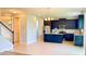 Modern kitchen with stainless steel appliances, dark cabinetry, and a granite island at 5107 Longmeadow Park St, Orlando, FL 32811