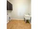 Laundry room with sink and overhead cabinets at 5107 Longmeadow Park St, Orlando, FL 32811