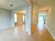 Spacious living room with tile floors, neutral paint, and natural light from large windows at 5107 Longmeadow Park St, Orlando, FL 32811